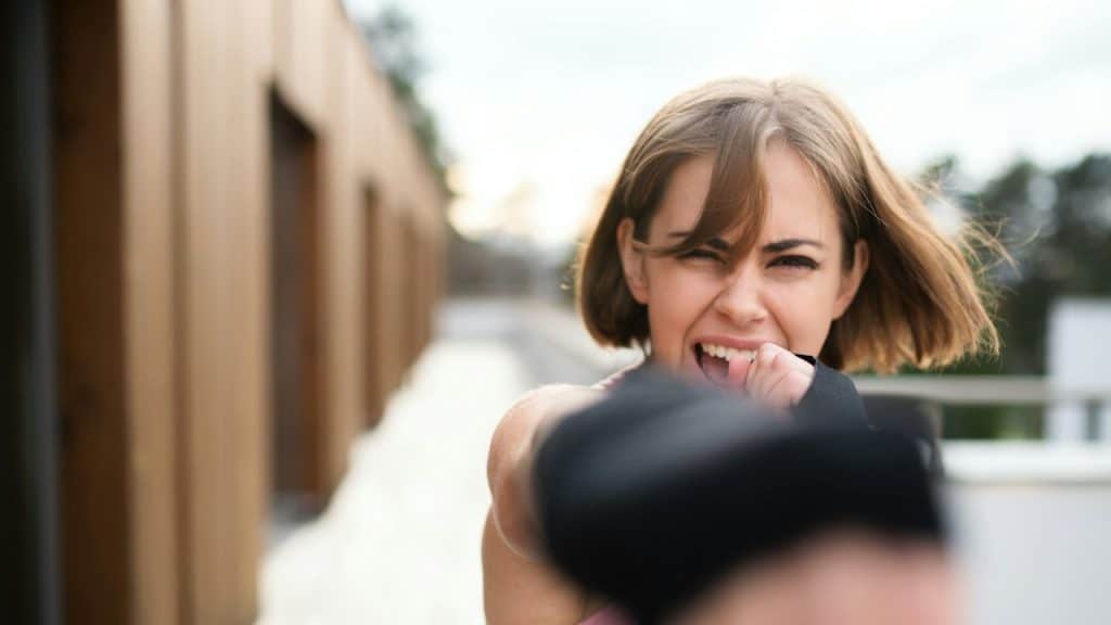 A woman screaming outdoors.