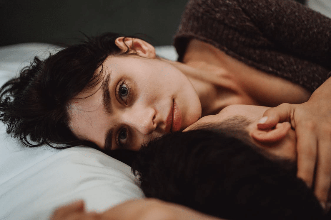 Couple lying down on bed