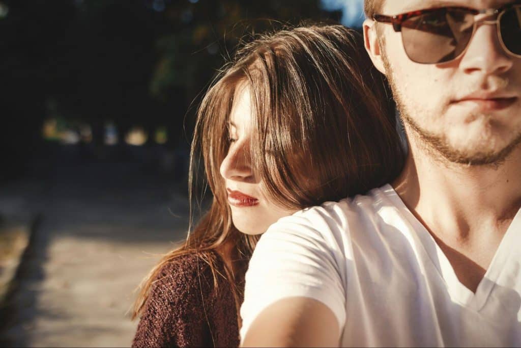 A woman hugging a man