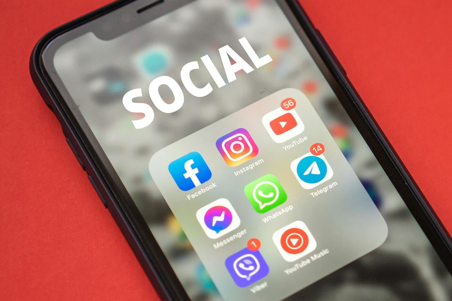 A phone with social media apps displayed on the screen.