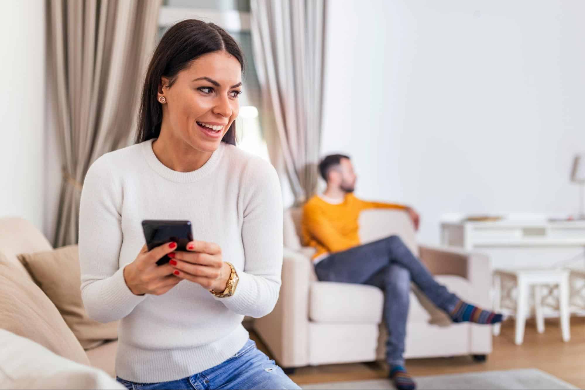 A woman doing something with her phone 