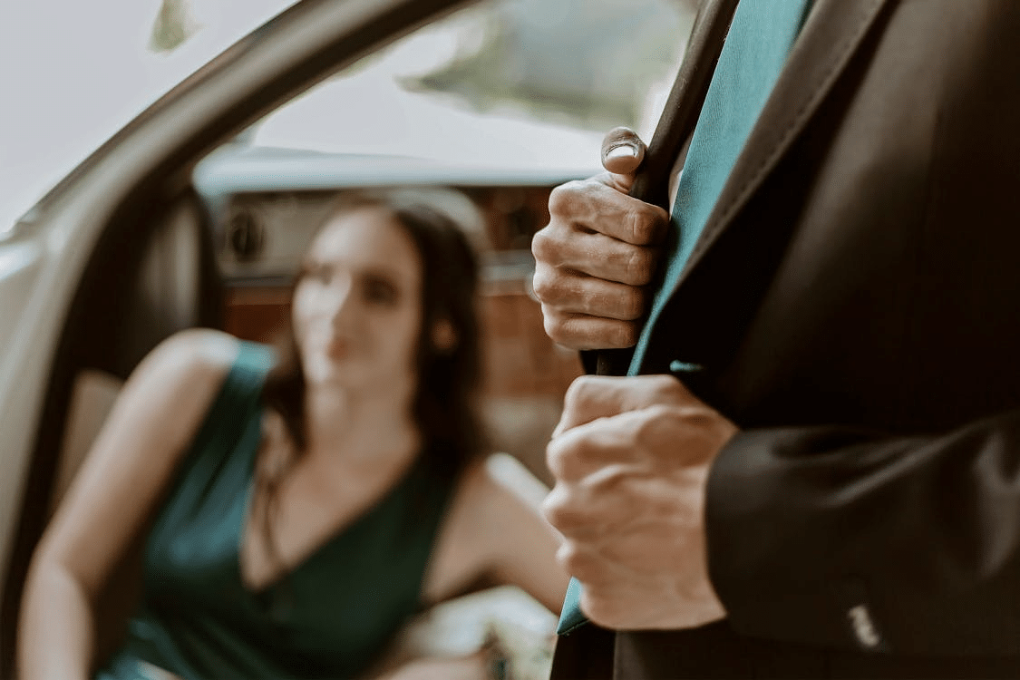 A man and a woman beside a car