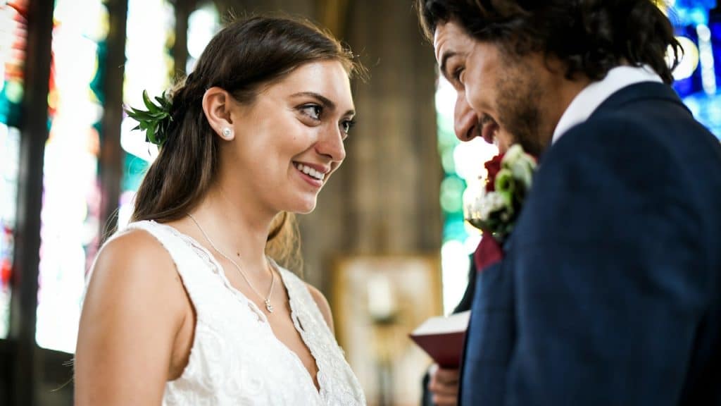 A happy bride and groom at the altar.