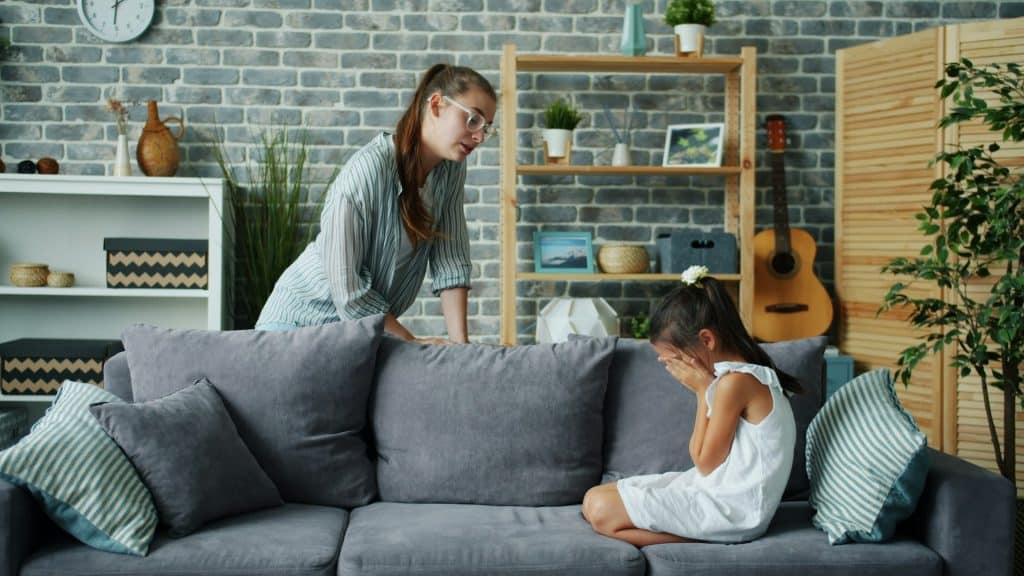 A mother talks to a crying daughter.