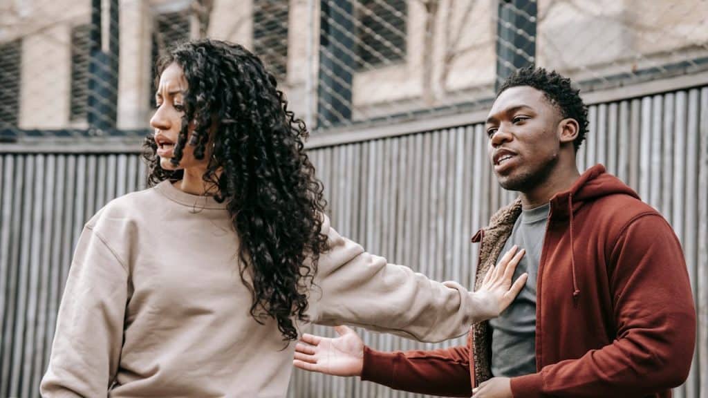 Man arguing with a woman who is turning away from him.