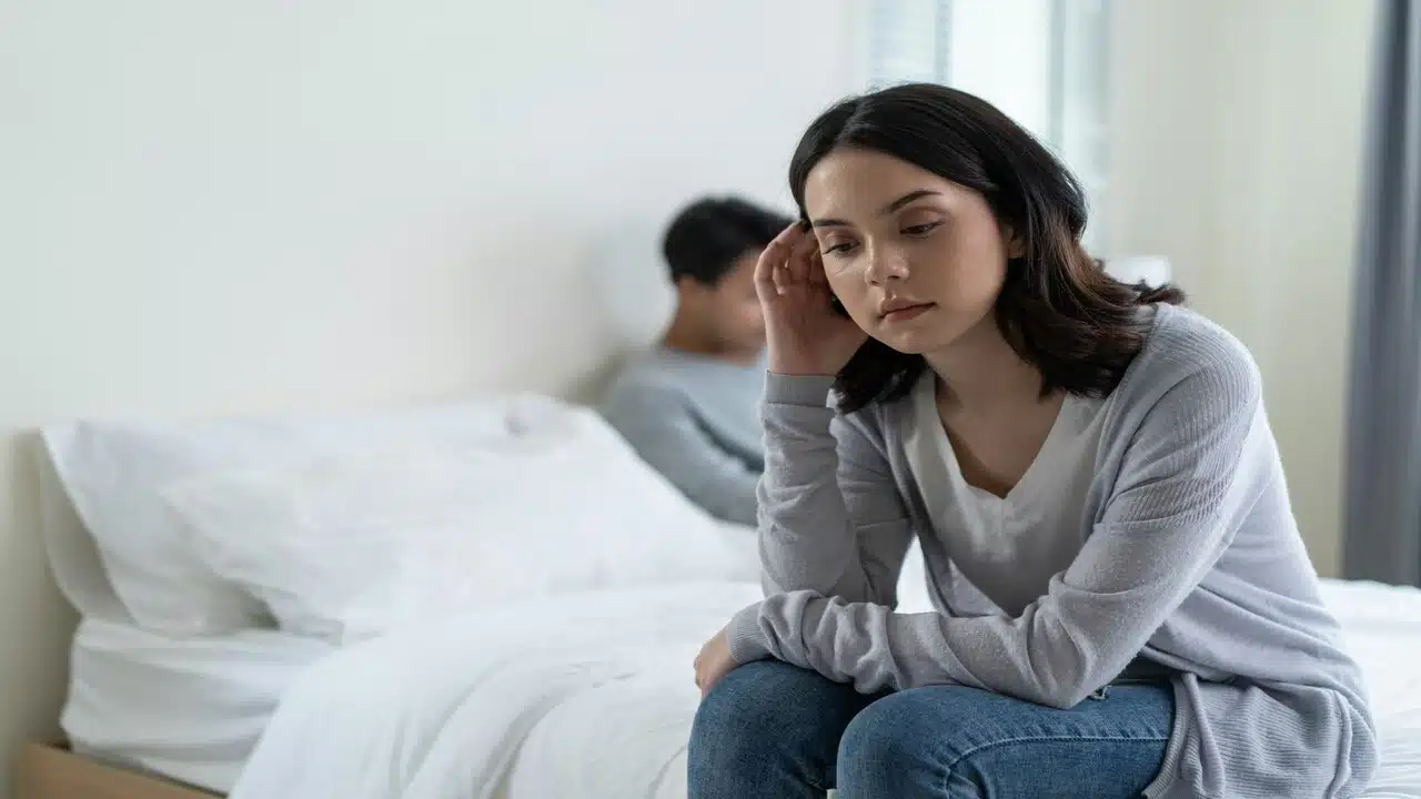 A woman looking sad in the bedroom