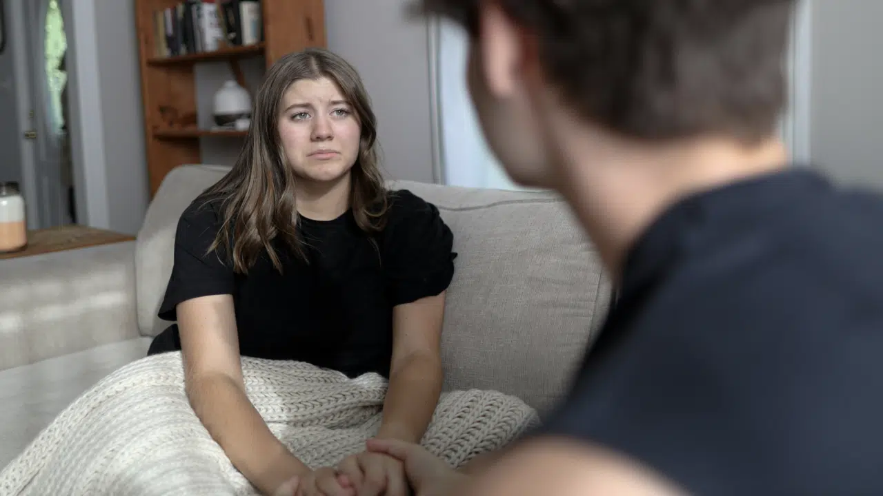 A woman crying while her husband is nonchalant