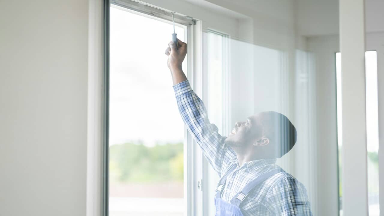 A man fixing the window