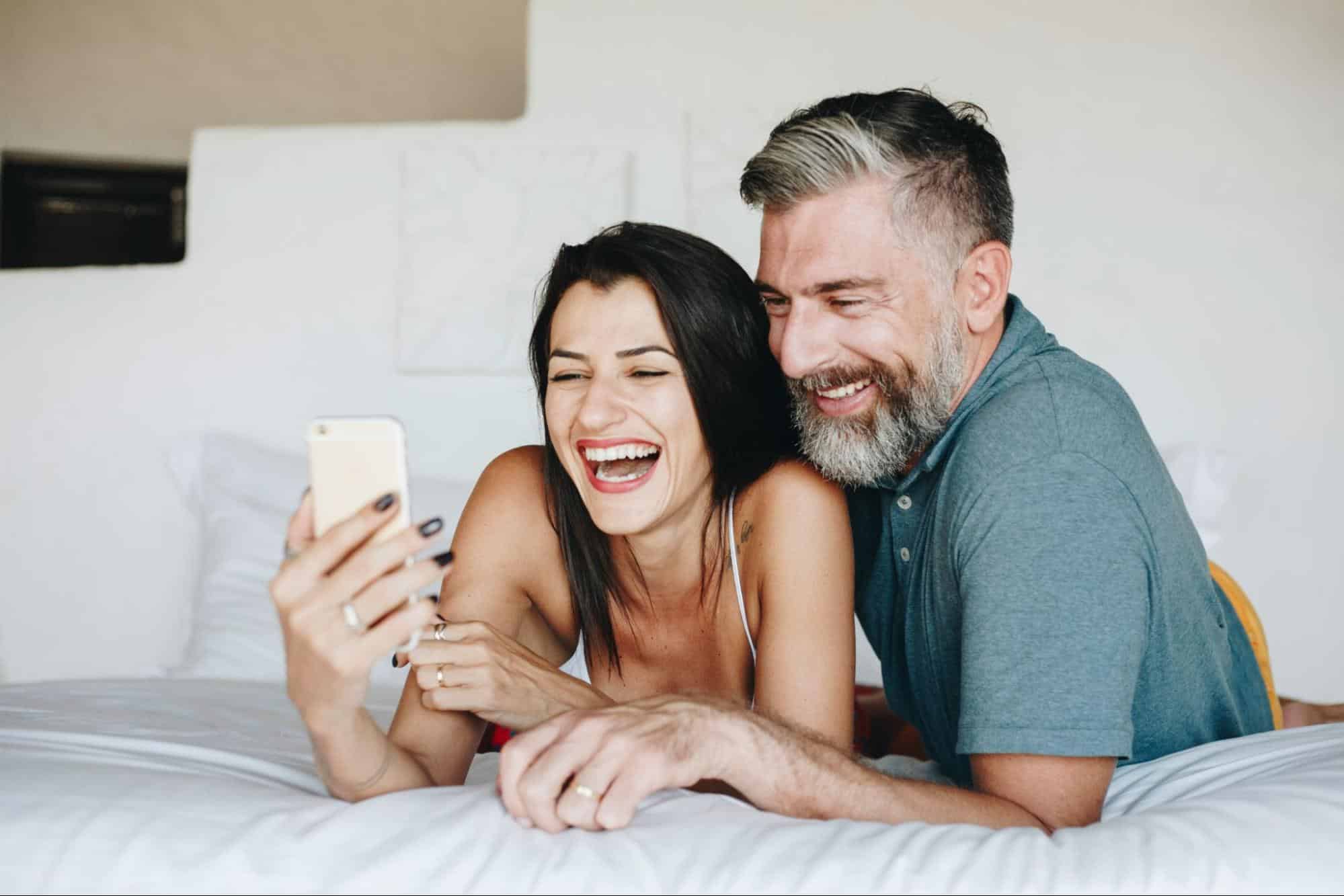 A man and woman looking at the phone