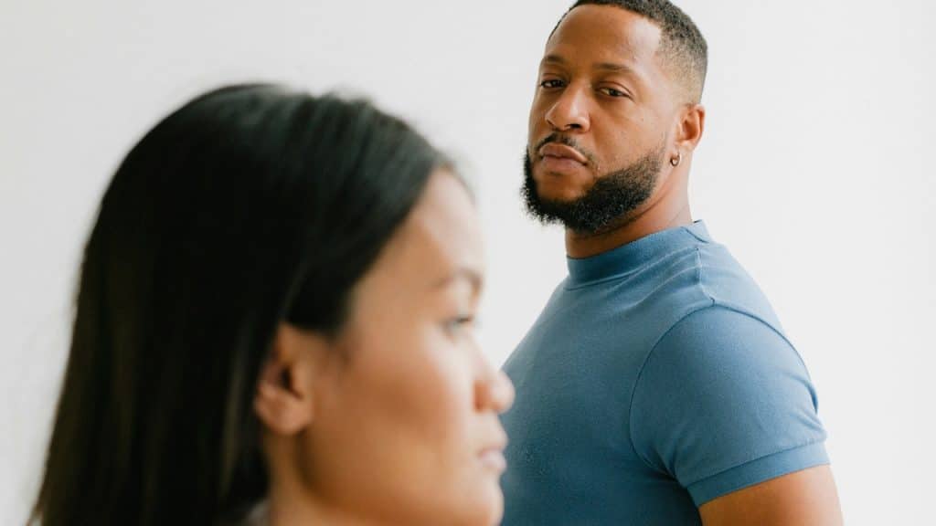 A bearded man looking at a woman.