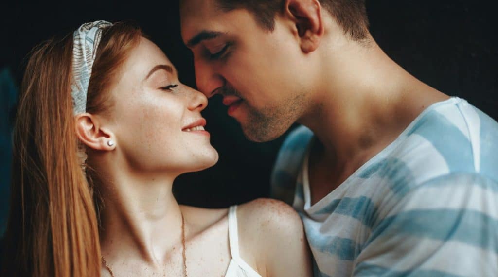 A man and woman about to kiss.