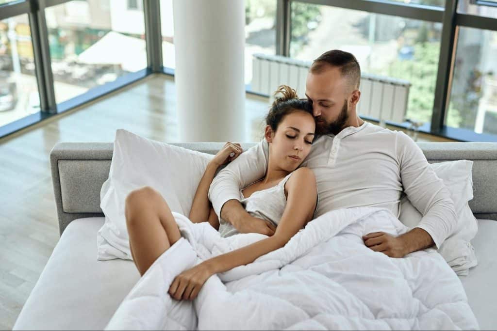 A man and woman at the bed
