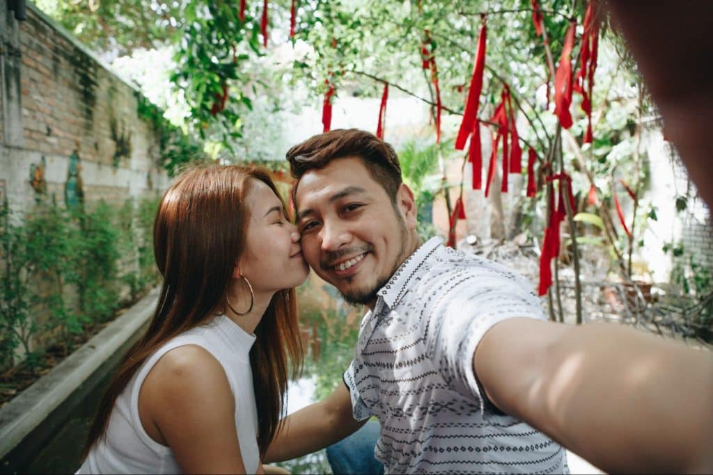 A woman kissing a man’s cheek
