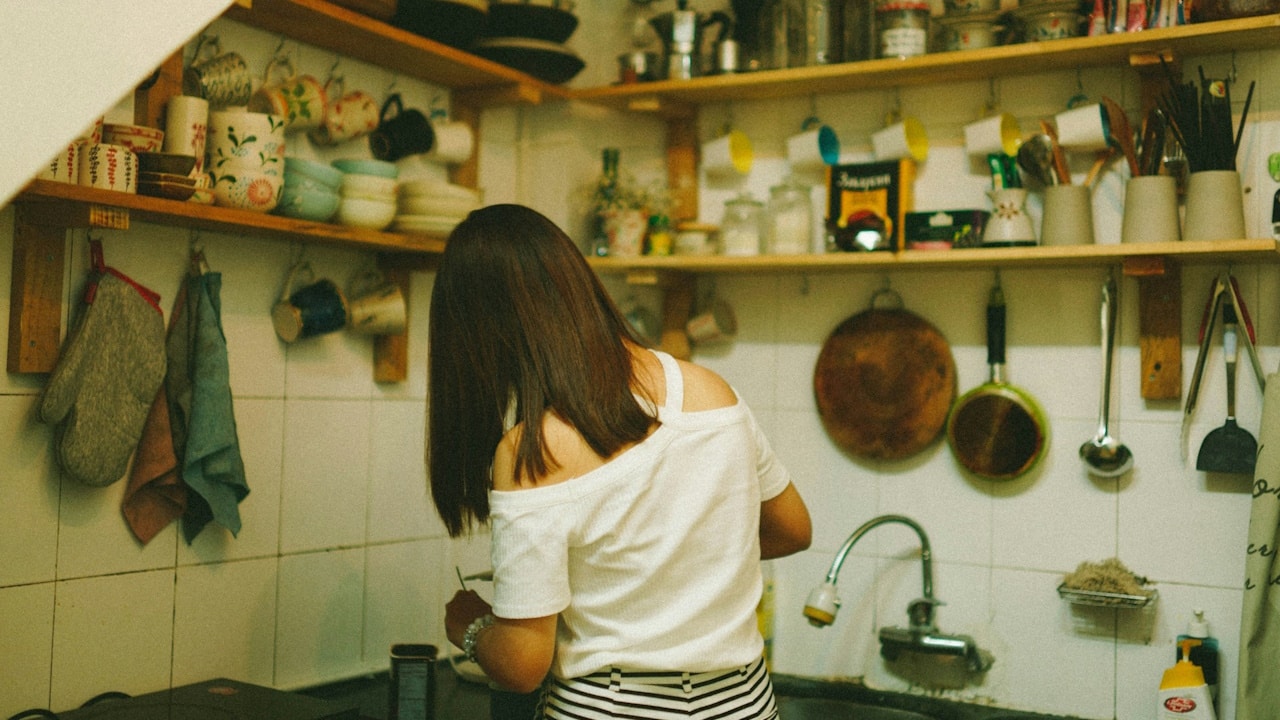 A woman cooking in the kitchen.