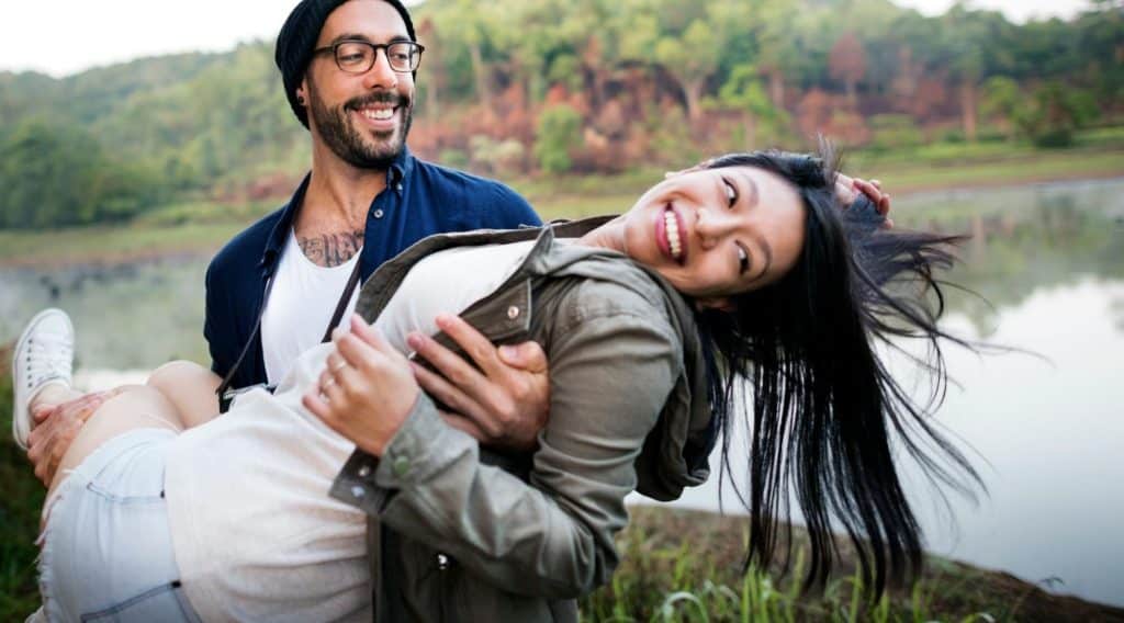 A man carrying a woman