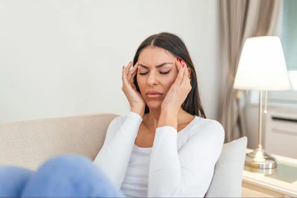 A woman holding her head 