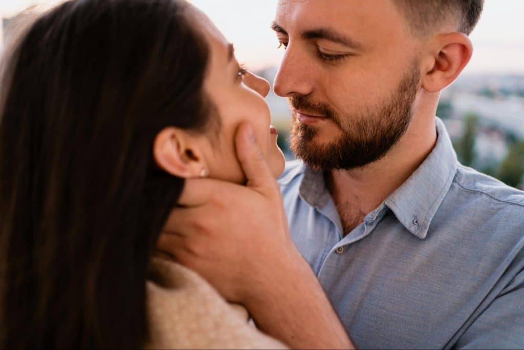 A man caressing a woman’s face