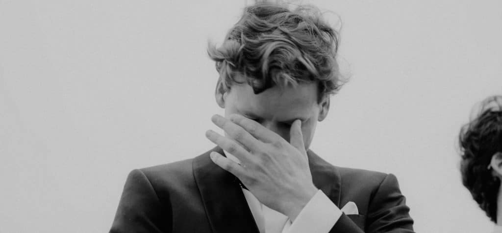 Black and white photo of a man crying.