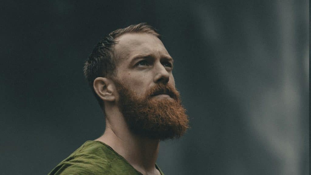 A bearded man gazing upwards.