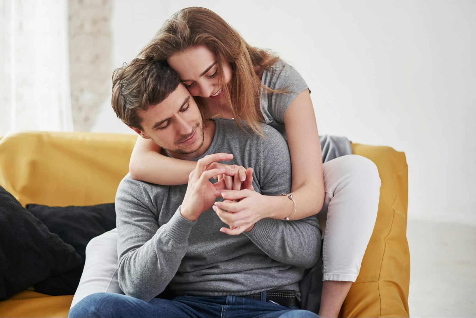 A woman hugging a man 