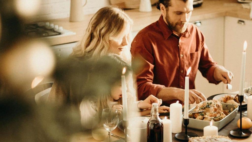 A family gathered around a candlelit dinner table.