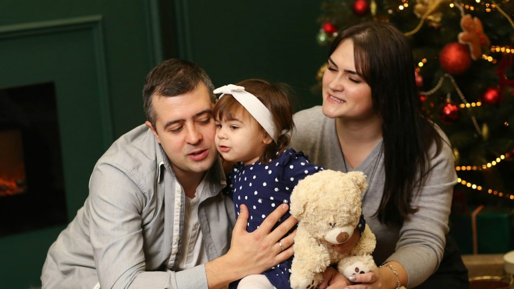 A couple playing with their child.