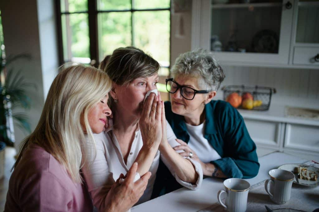 Female friends comforting a sad friend.