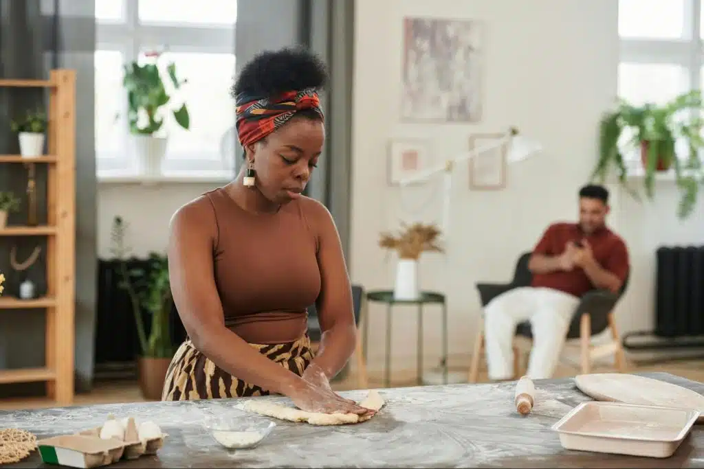 A woman busy kneading a dough
