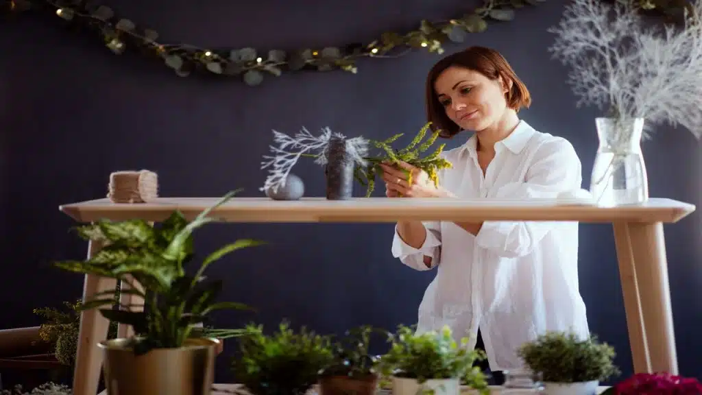 A mature woman arranging flowers