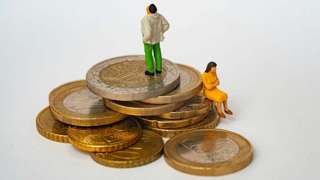 An illustration of a couple sitting atop coins signaling financial transparency. 