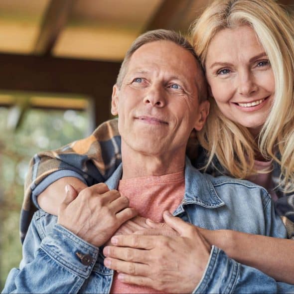 A woman hugging a man