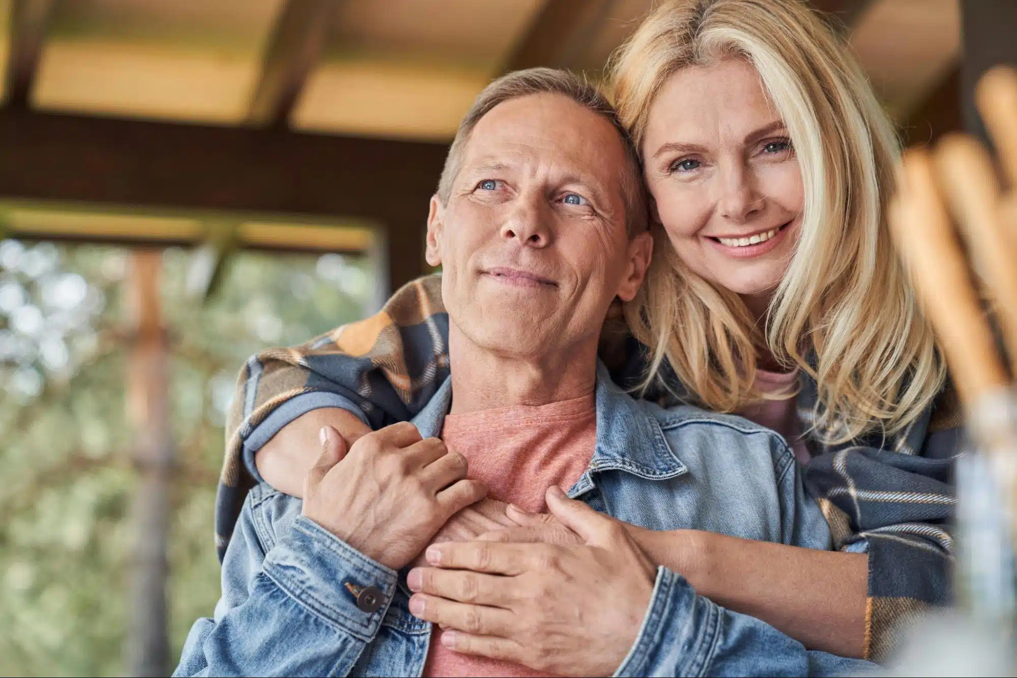 A woman hugging a man 