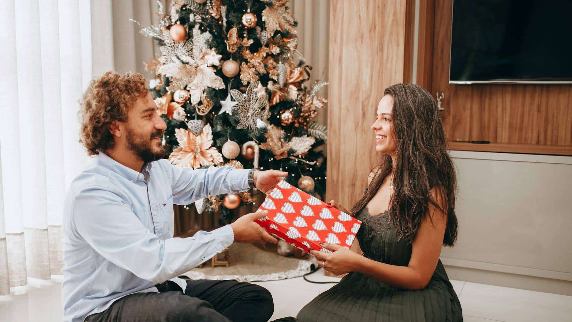 A man giving the woman a gift.