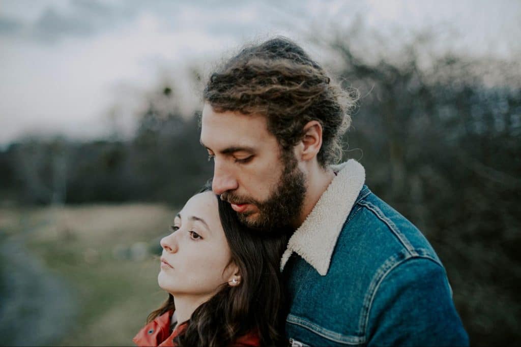 A man behind the woman for support