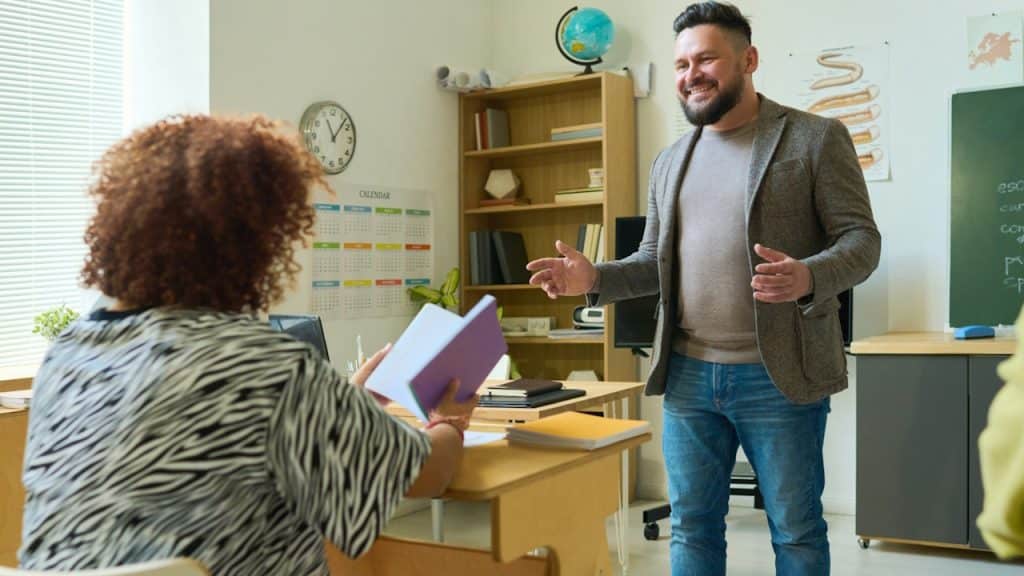 A male teacher explaining something to a female student.