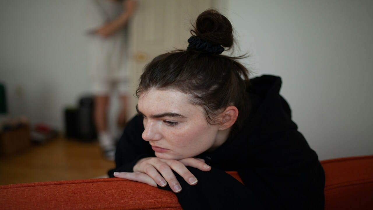 A woman looking sad at home