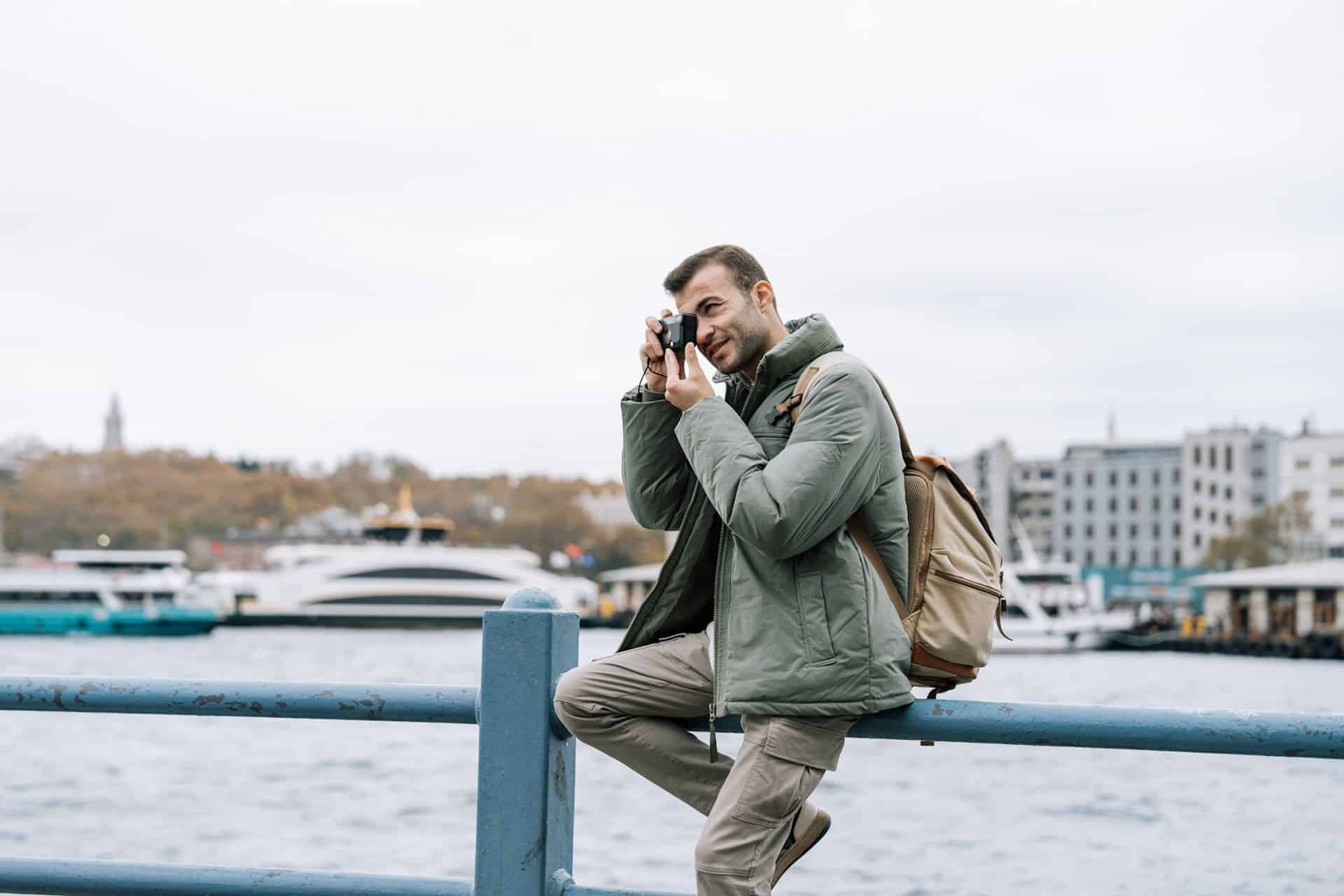 A man taking a picture while exploring the city.
