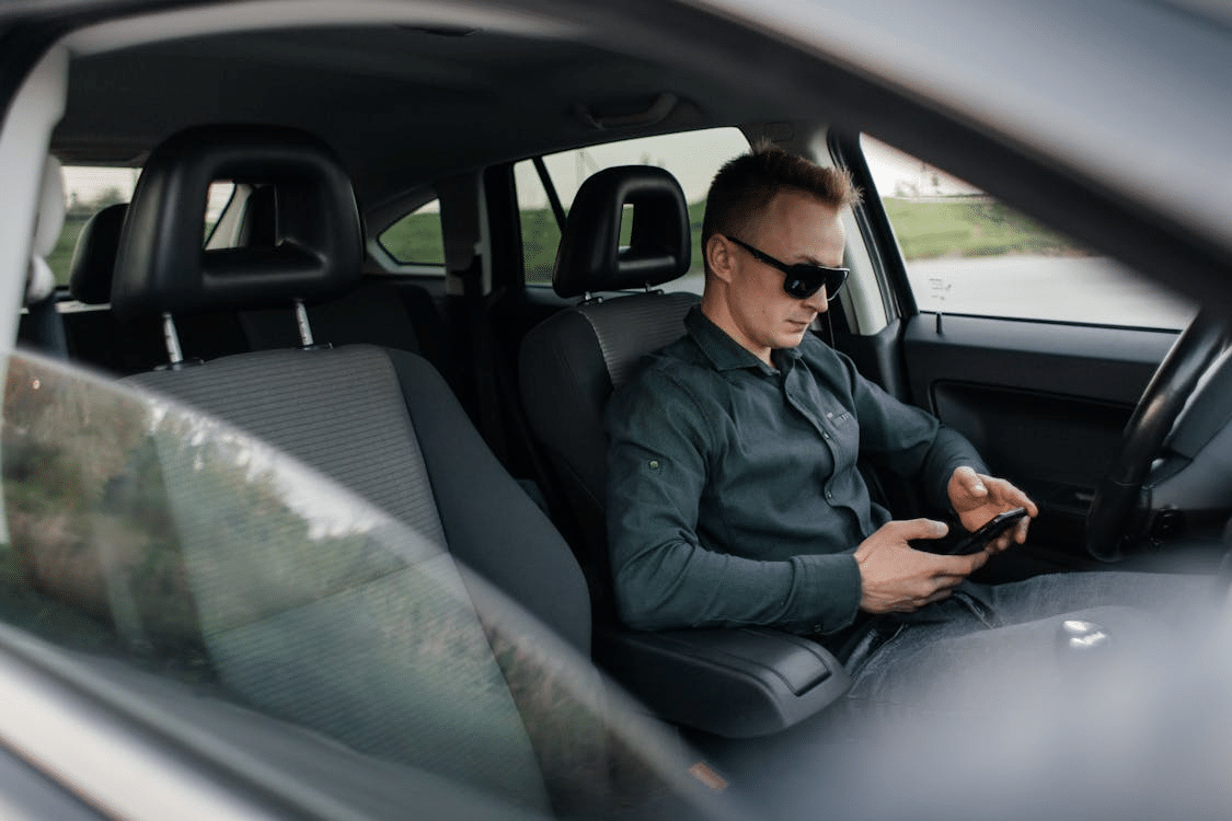 A man using his phone in a car