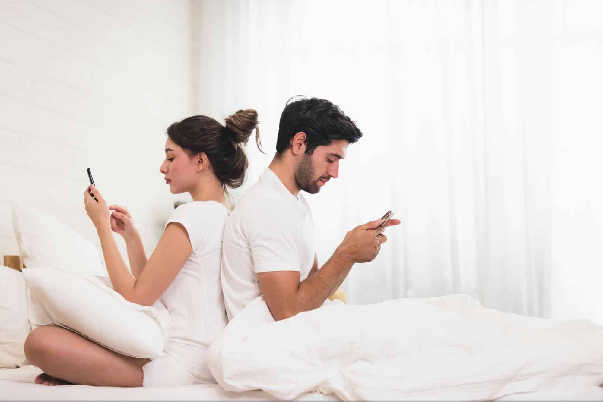 A man and woman busy with their phones