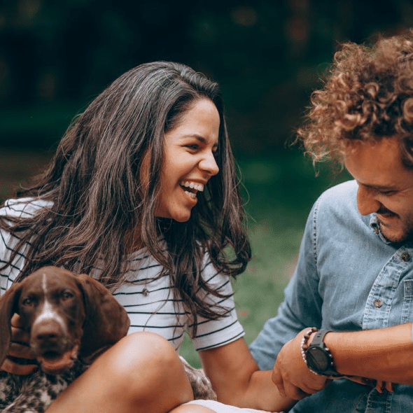 A man and a woman with a dog