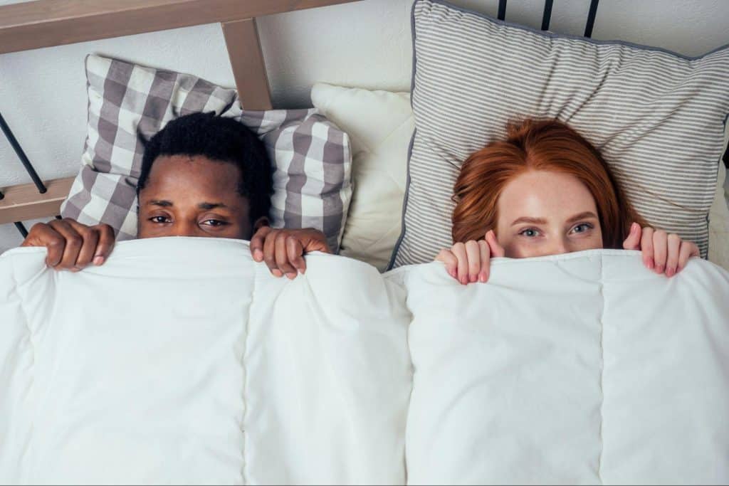 A man and woman at the bed
