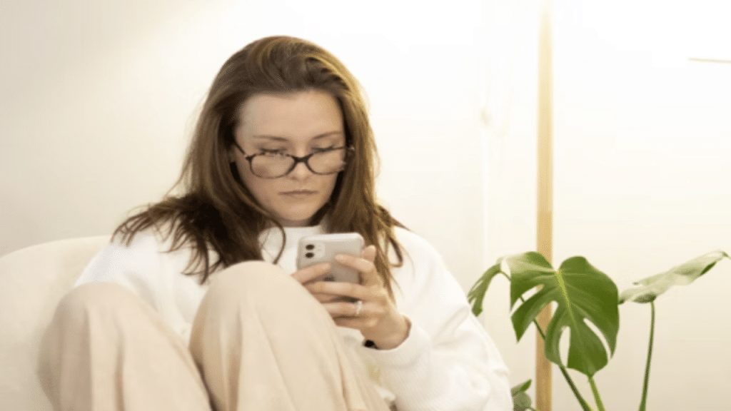 A woman looking concerned while texting