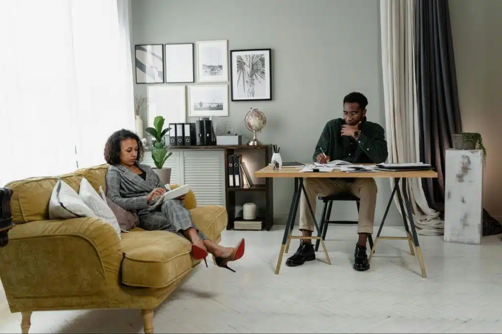 A man and woman at the same room but not talking to each other