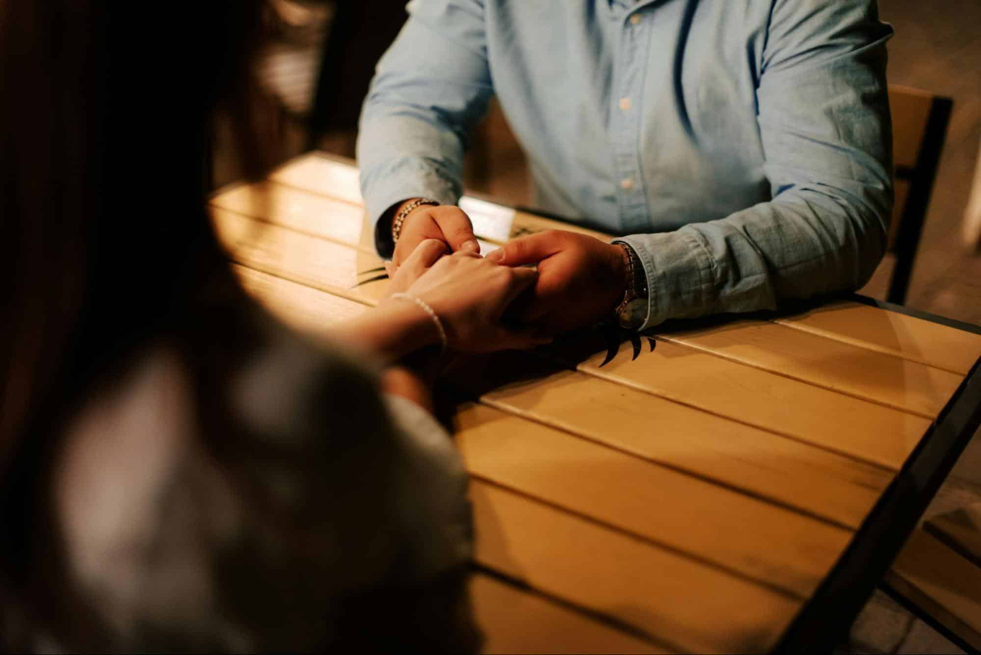 A man holding a woman’s hand