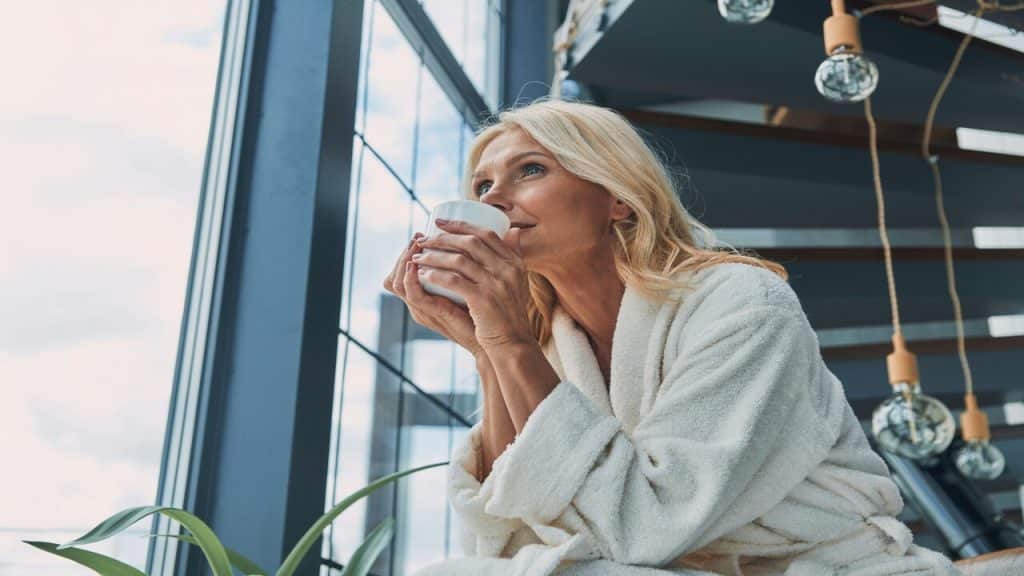 A woman having coffee at home