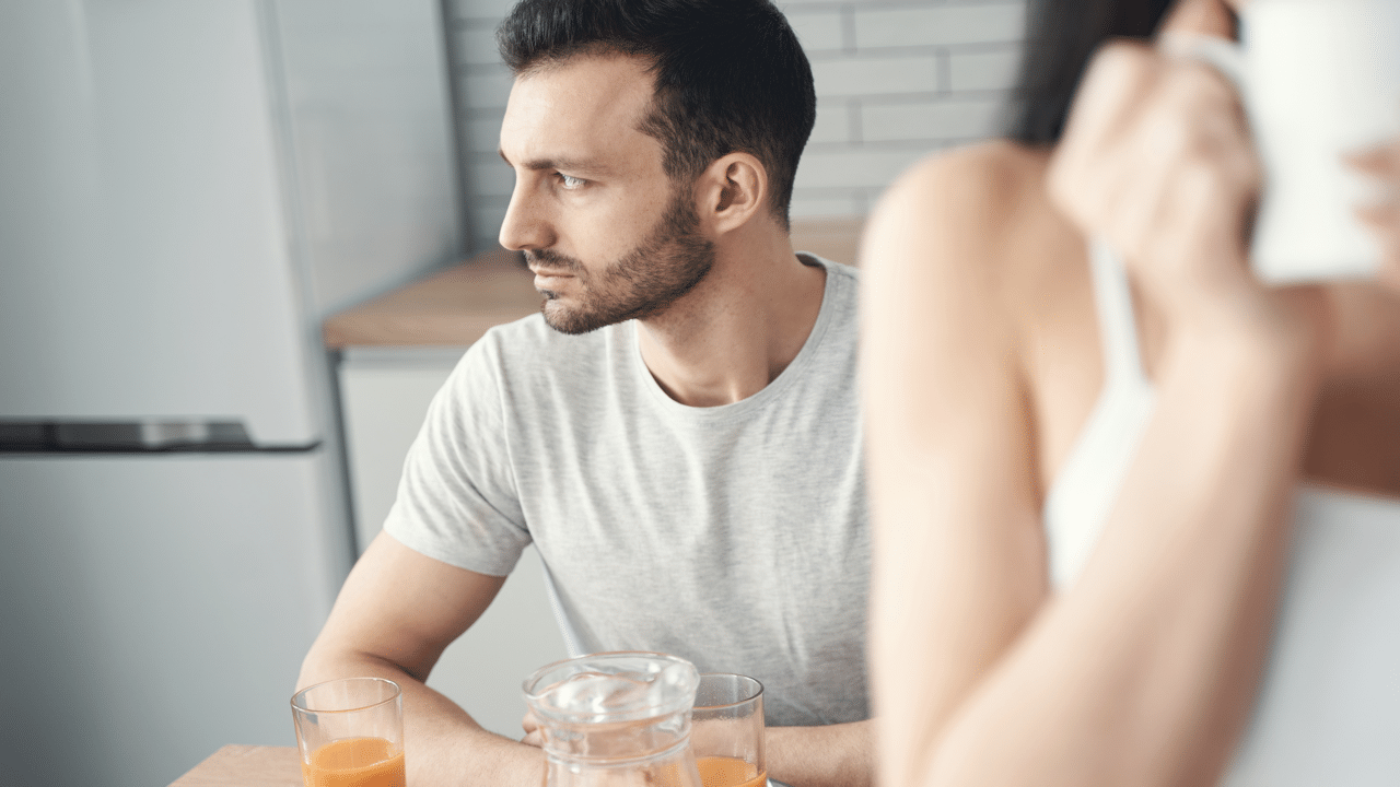 A man looking ambivalent during breakfast