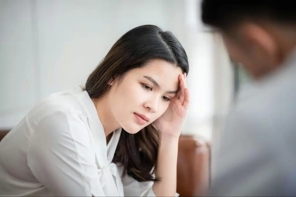 A woman not having a reaction while talking to man