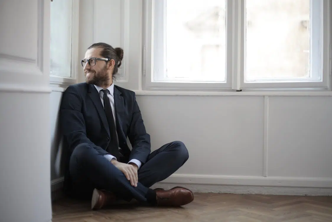 A man smiling while sitting on the floor
