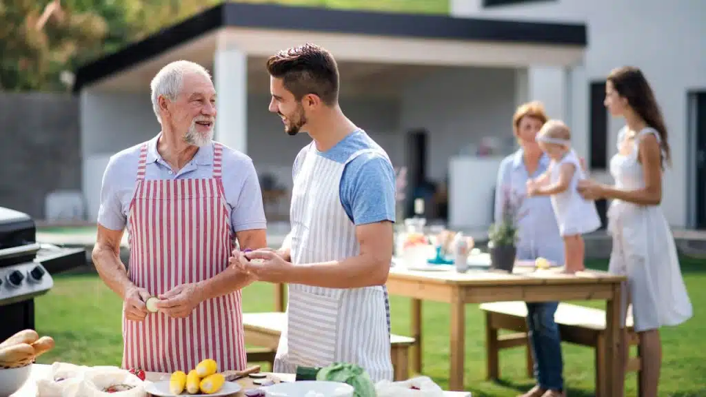 A family having a barbecue outdoors together.