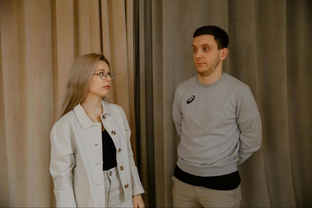 A man and woman looking awkward